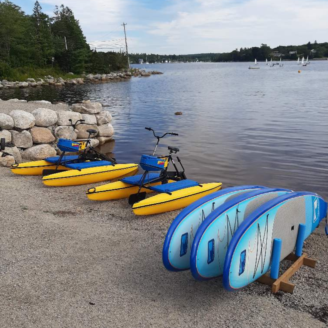 Photo of water bikes and stand up paddle boards by the water