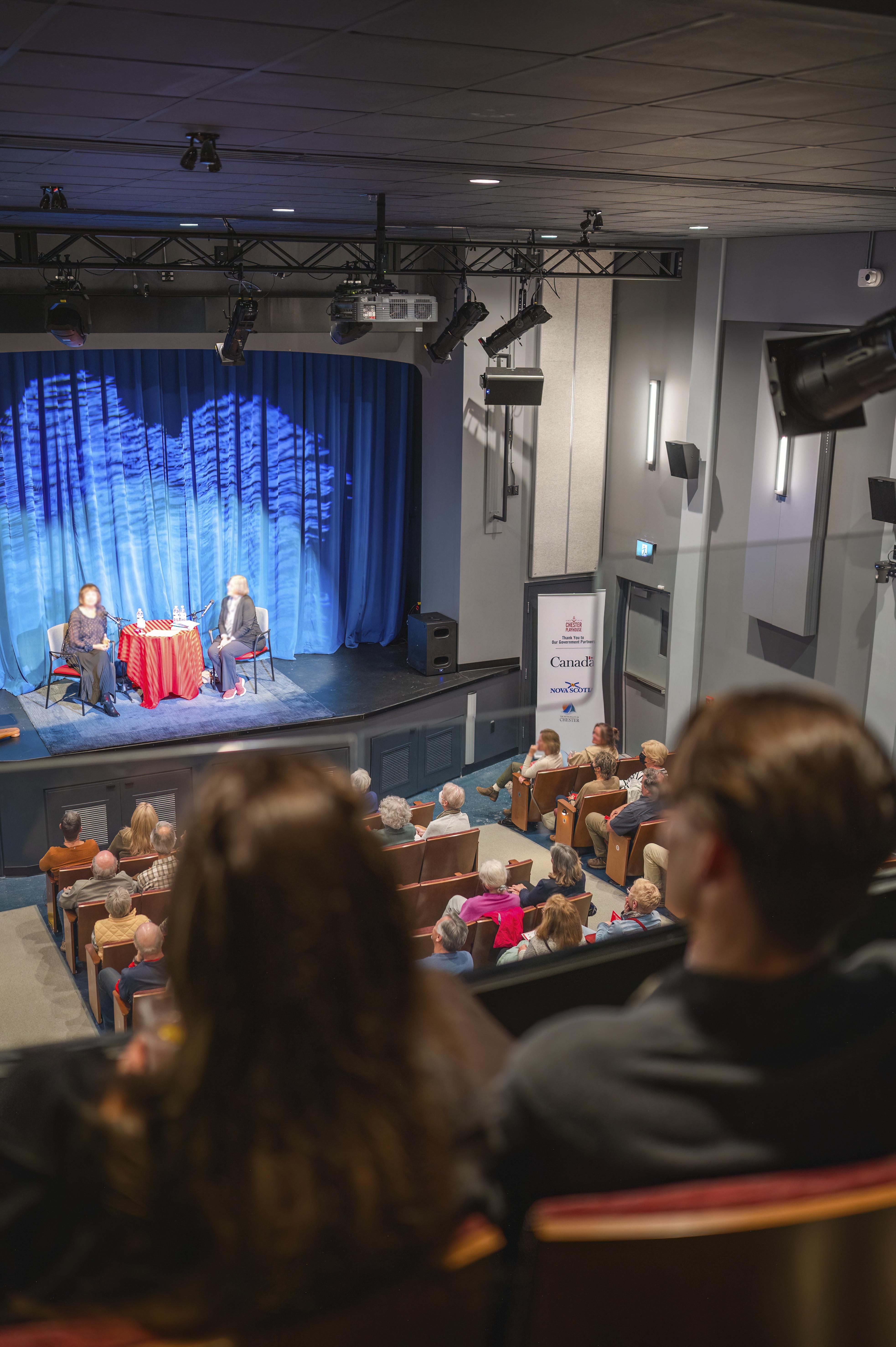 Photo of an audience inside the Chester Playhouse overlooking the stage