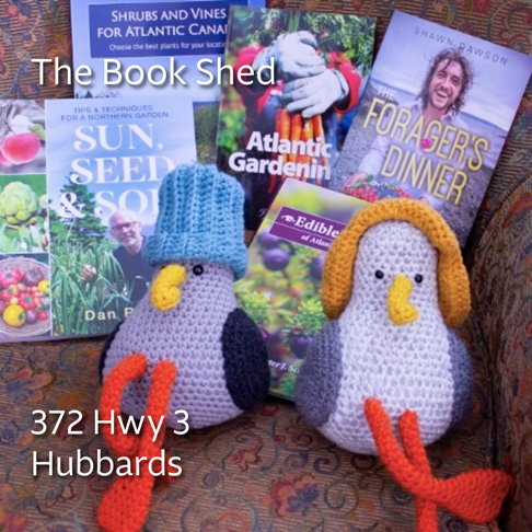 Photo of two knitted seagulls and a selection on local NS books