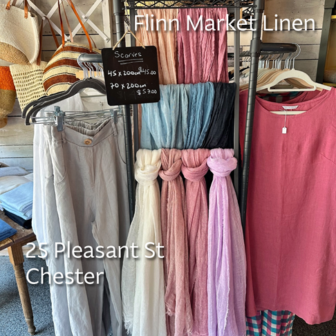 Photo of scarves, pants, and shirts hanging