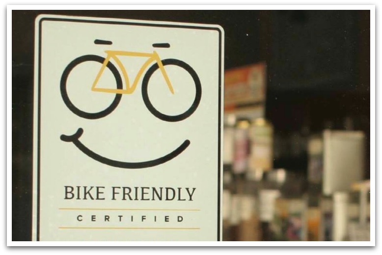 Label with a bicycle and smiley face with text "Bike Friendly certified".