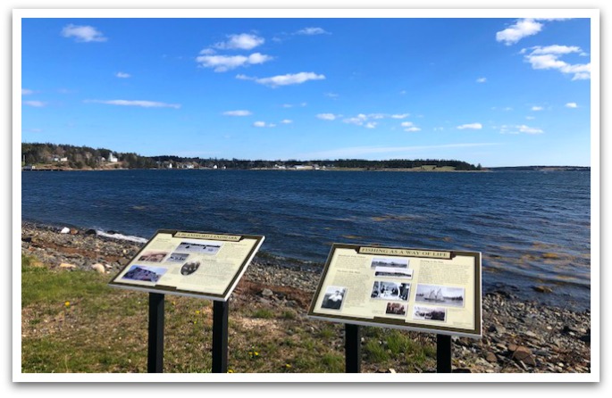 Two information panels on the coast facing the ocean.