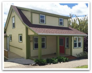 photo of art centre building, a yellow building with green trim.