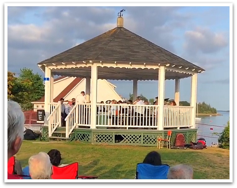 Photo of bandstand at golden hour with brass band playing