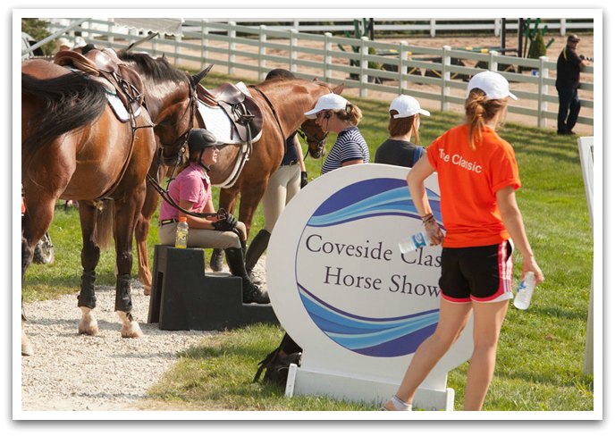 riders taking a break next to horses