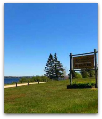 Sign by trail next to water