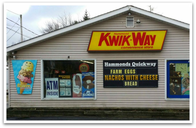 Exterior of Kwik-Way advertising deals, their ATM, and ice cream