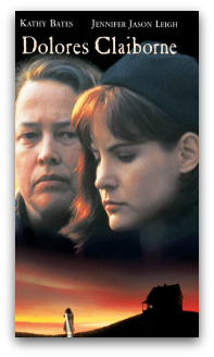 Kathy Bates and Jenifer Jason Leigh fading to a sunset over the silhouette of a house on a hill. Text reads "Dolores Clairborne".