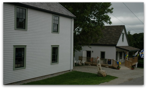 Woman in traditional clothes walking past maple cottage