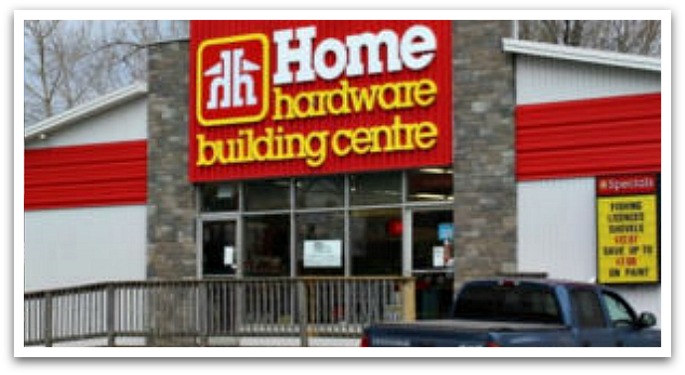 Home Hardware building with a blue truck parked outside.
