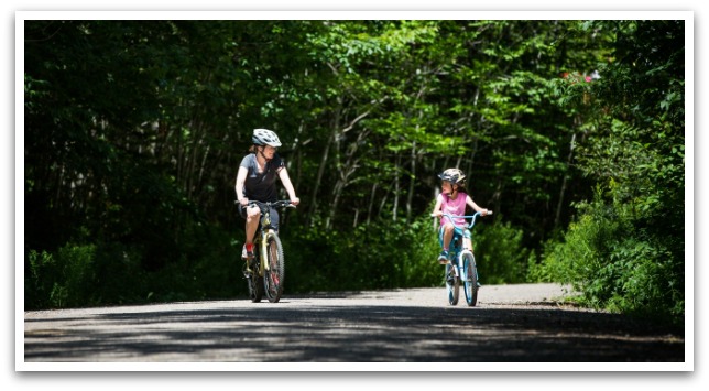 mother and daughter riding bikes on a trail