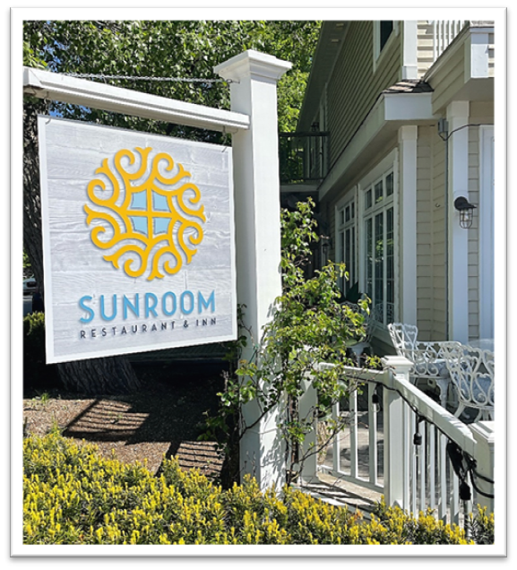 sign outside the restaurant reading "Sunroom restaurant and inn".