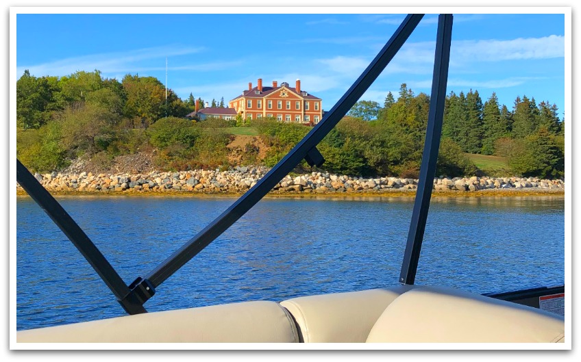 Large, old brick house facing the ocean taken from a boat.