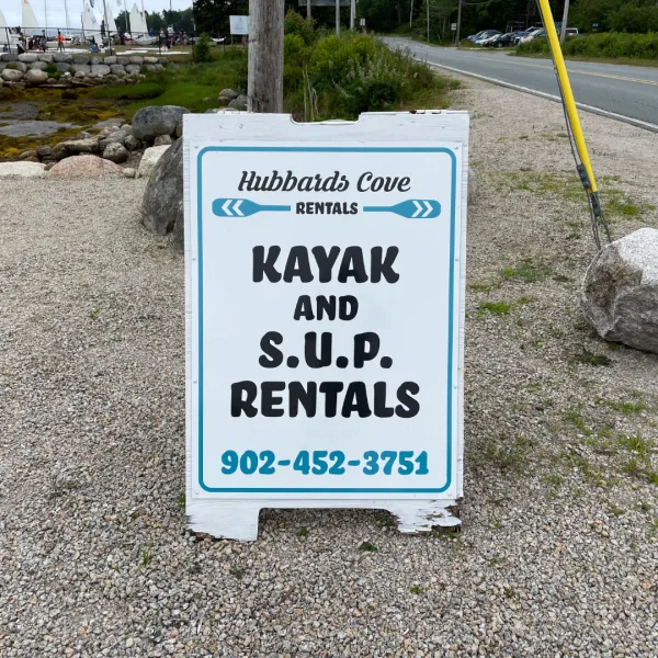 Photo of Hubbards Cove Rentals Sign with Kayak and S.U.P Rentals in black print
