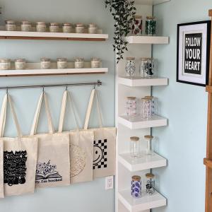 Scented candles, totes, and drink glasses