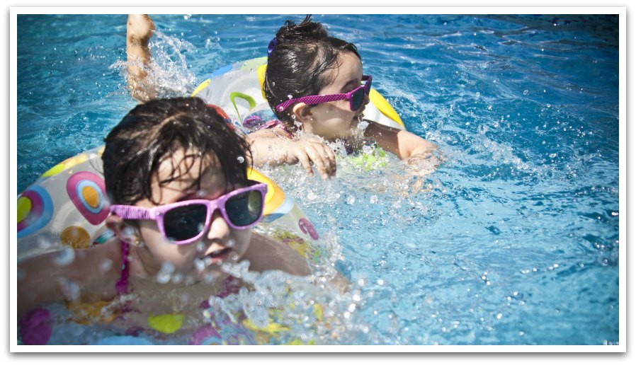 Kids swimming in a pool wearing sun glasses