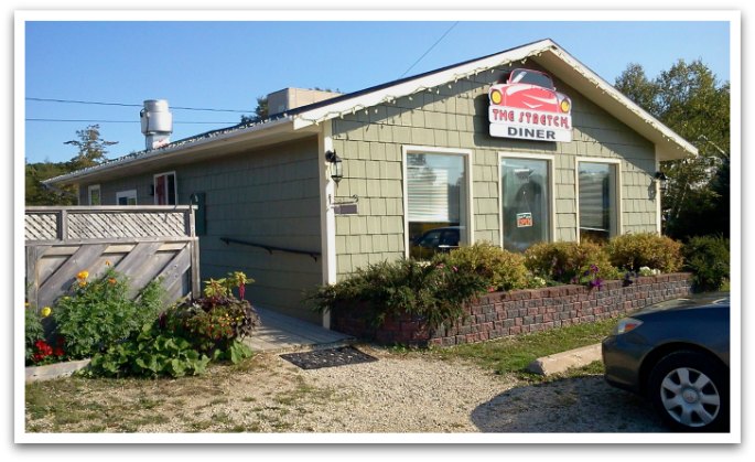 Exterior of The Stretch Diner showing 50s style sign with a red car on it