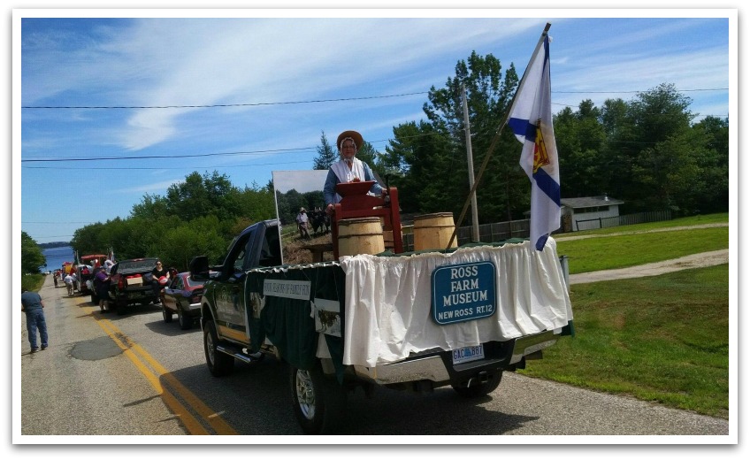 Lady from Ross Farm Museum on a pickup truck float wearing old fashioned clothing part of the parade.